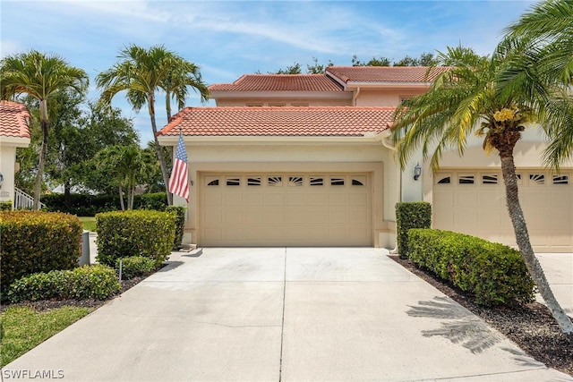 mediterranean / spanish-style house with a garage