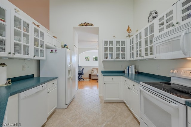 kitchen featuring light hardwood / wood-style floors, white cabinets, and white appliances