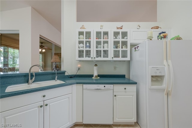 kitchen with white appliances, sink, white cabinets, and ceiling fan