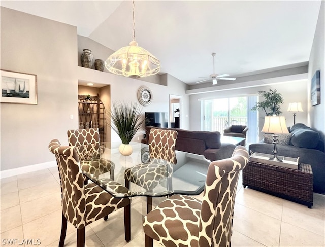 dining space with ceiling fan with notable chandelier, light tile patterned flooring, and lofted ceiling