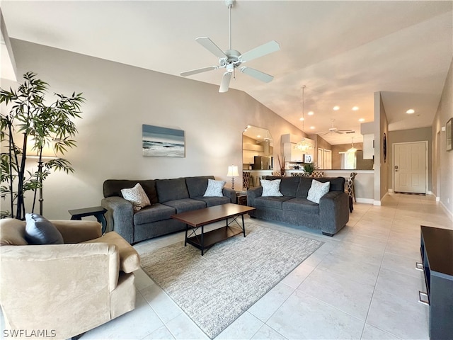 living room with ceiling fan, light tile patterned floors, and vaulted ceiling