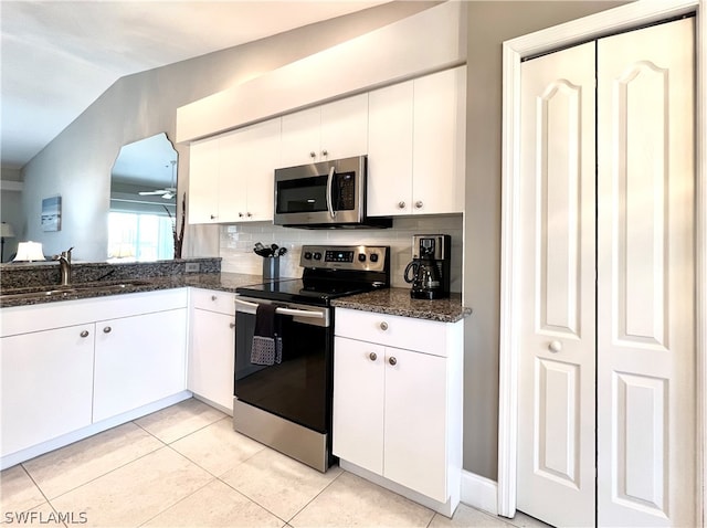 kitchen featuring white cabinets, sink, vaulted ceiling, ceiling fan, and stainless steel appliances