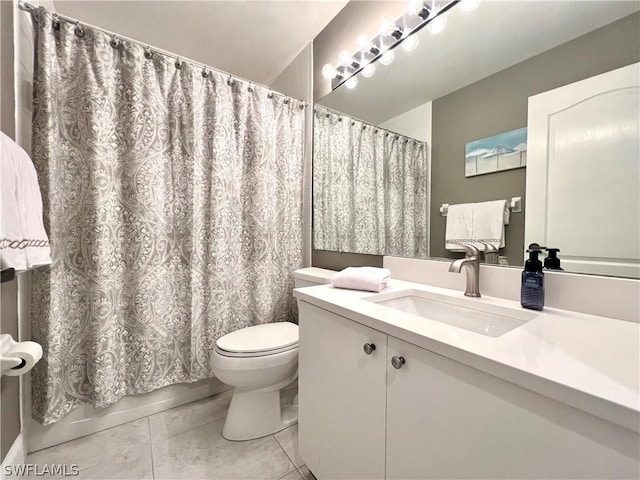 bathroom featuring tile patterned flooring, vanity, and toilet