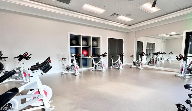 exercise room with a paneled ceiling and ornamental molding