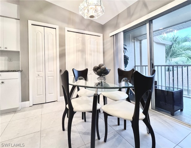 tiled dining area with a chandelier