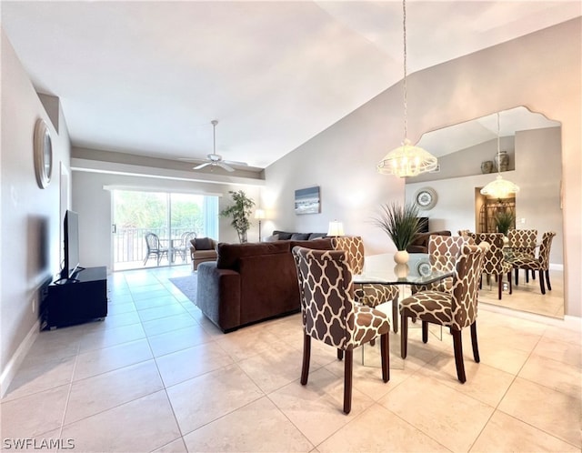 tiled dining area with ceiling fan and lofted ceiling