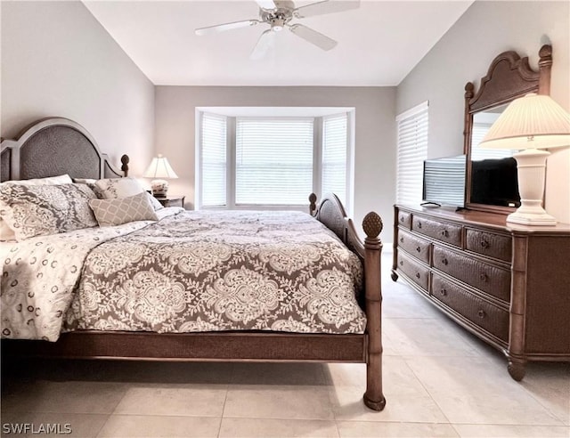 bedroom with ceiling fan, light tile patterned floors, and vaulted ceiling