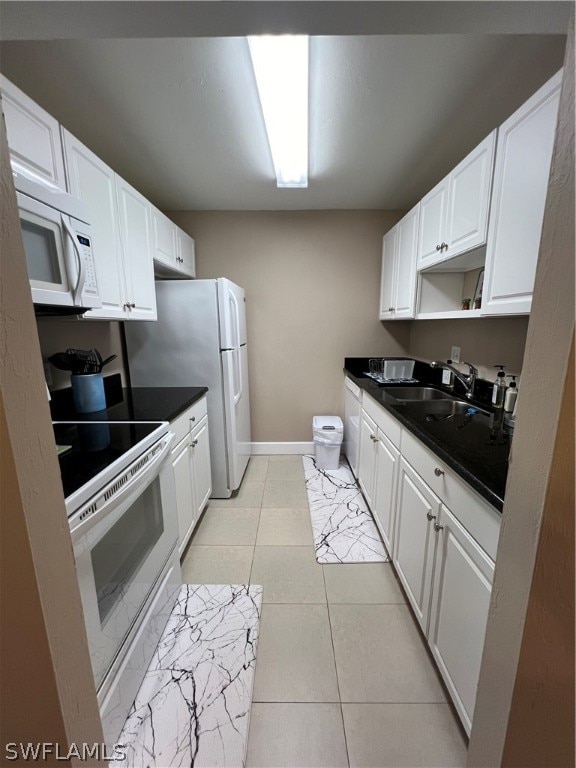 kitchen featuring sink, white cabinetry, and white appliances