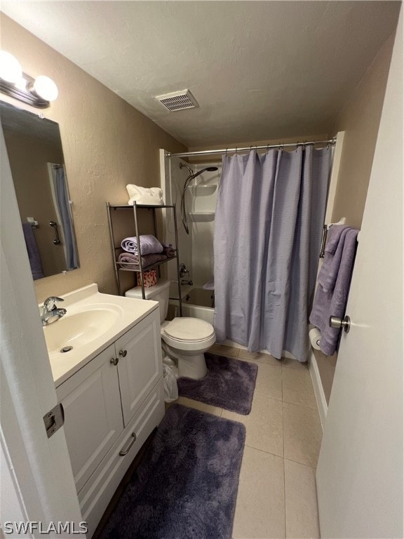 full bathroom with tile flooring, shower / tub combo with curtain, vanity, and toilet