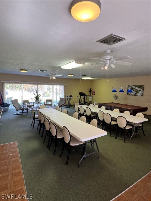 carpeted dining room featuring ceiling fan