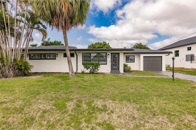 single story home with a garage and a front lawn