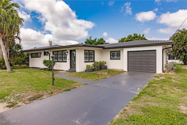 view of front of house featuring a garage and a front yard