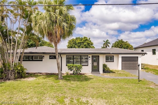 view of front of home with a front yard and a garage