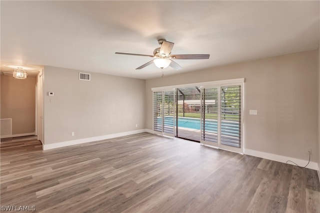 empty room featuring wood-type flooring and ceiling fan