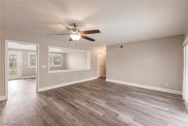 unfurnished room featuring ceiling fan and hardwood / wood-style floors