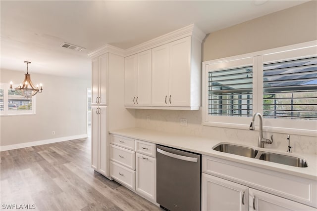 kitchen with dishwasher, a notable chandelier, white cabinetry, light wood-type flooring, and sink