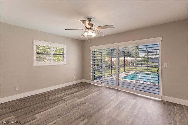 spare room with wood-type flooring and ceiling fan