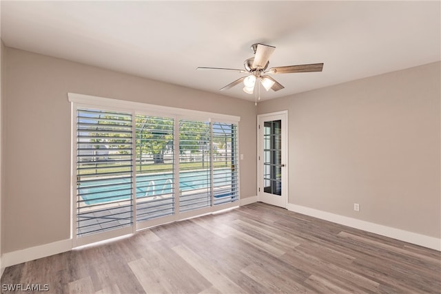 spare room featuring wood-type flooring and ceiling fan