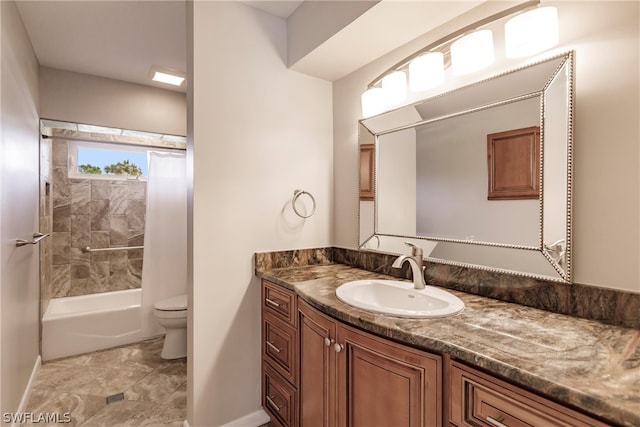 full bathroom featuring tile floors, tiled shower / bath, vanity with extensive cabinet space, and toilet