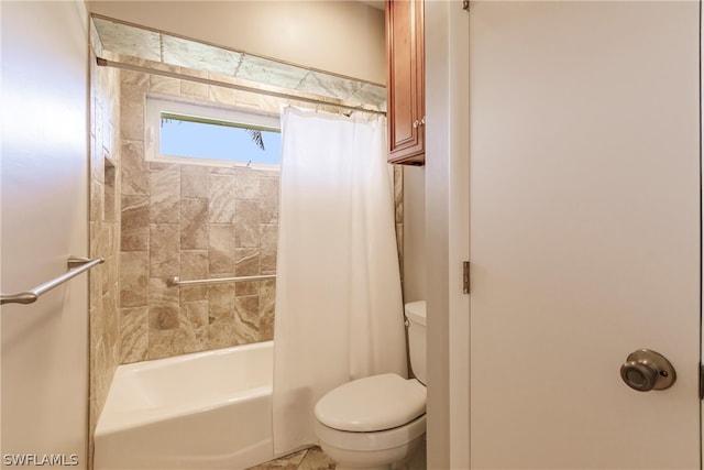 bathroom featuring toilet and shower / bath combo with shower curtain