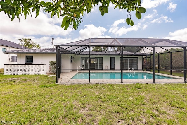 view of pool with a patio area, a lanai, and a yard