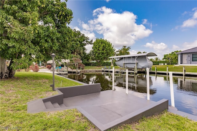 dock area with a lawn and a water view