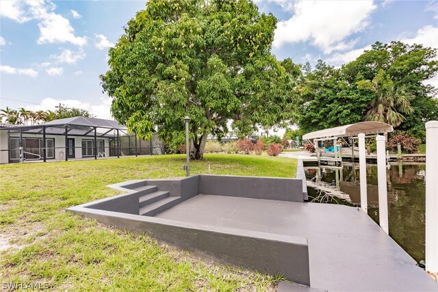 view of yard featuring a boat dock, a lanai, and a water view