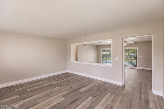 spare room featuring hardwood / wood-style floors and ceiling fan