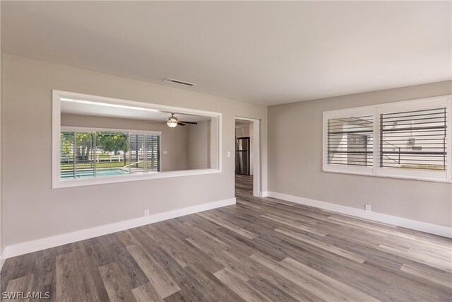 unfurnished room with ceiling fan and wood-type flooring