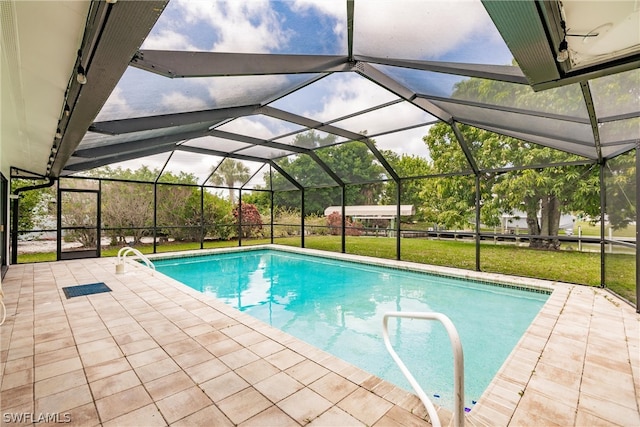 view of swimming pool with a patio, a lanai, and a yard