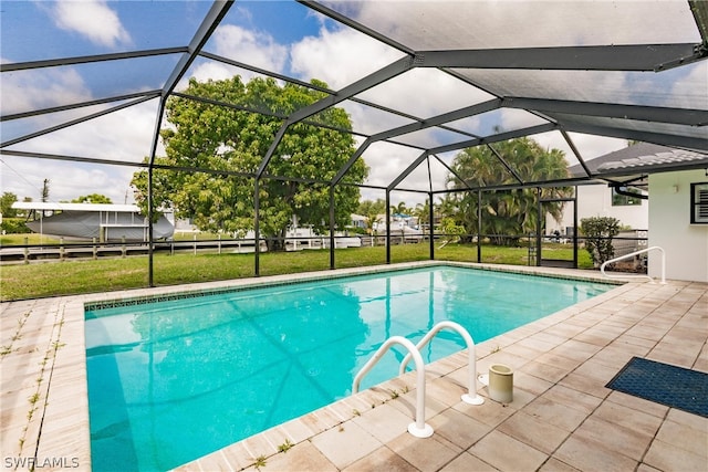 view of swimming pool with a yard, a lanai, and a patio area