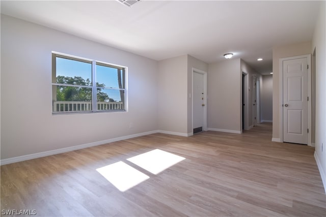 unfurnished room featuring light hardwood / wood-style floors