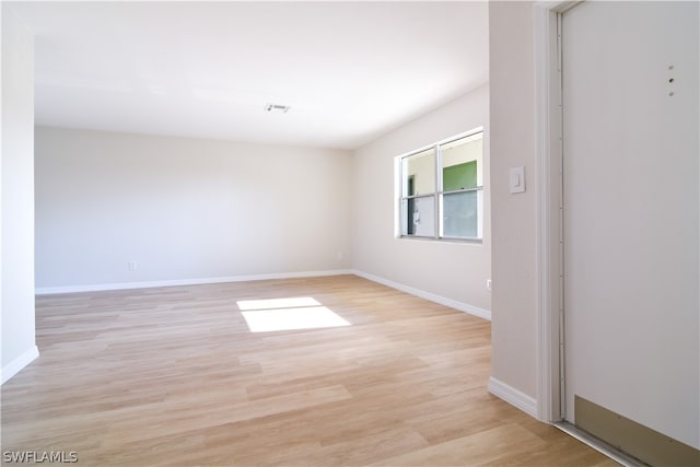 unfurnished room with light wood-type flooring