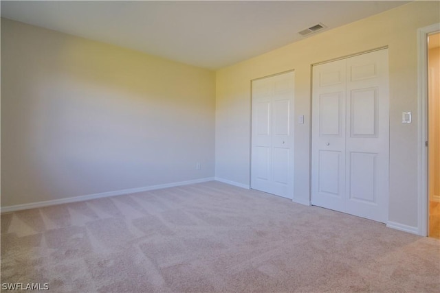 unfurnished bedroom featuring light colored carpet