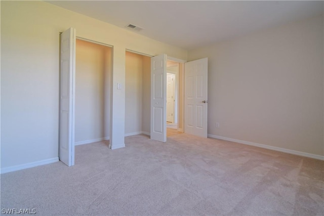 unfurnished bedroom featuring light colored carpet