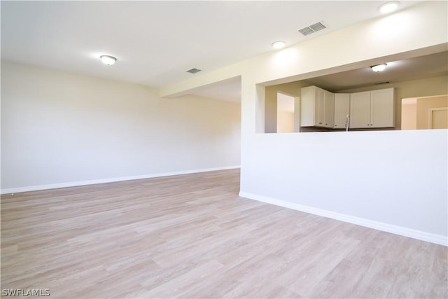 spare room featuring light wood-type flooring