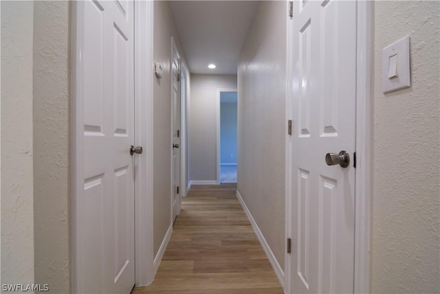 corridor featuring light hardwood / wood-style floors