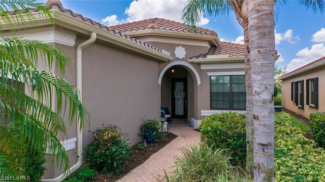 11643 Meadowrun Cir, Fort Myers, FL 33913 - property entrance with stucco siding and a tile roof