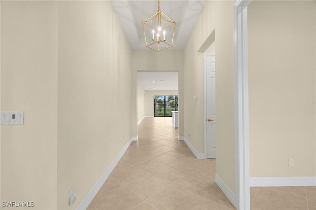 11643 Meadowrun Cir, Fort Myers, FL 33913 - hall with a chandelier, light tile patterned floors, and baseboards