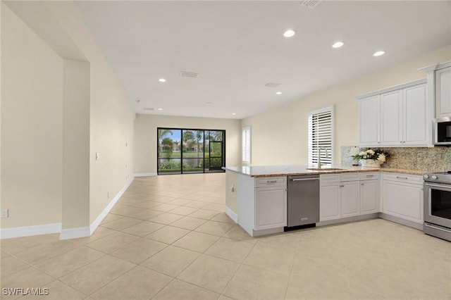 11643 Meadowrun Cir, Fort Myers, FL 33913 - kitchen with stainless steel appliances, white cabinetry, tasteful backsplash, open floor plan, and recessed lighting