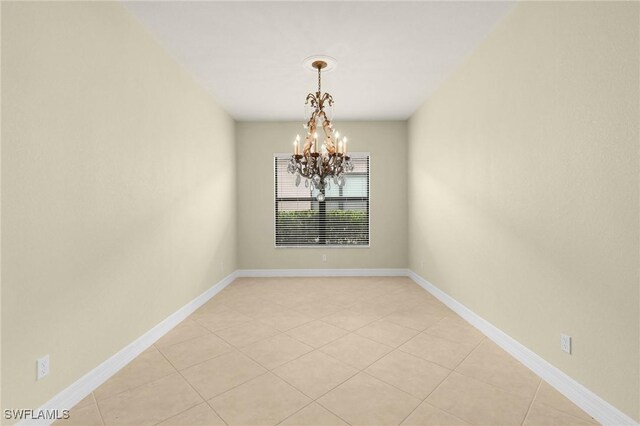 11643 Meadowrun Cir, Fort Myers, FL 33913 - unfurnished room featuring a chandelier, light tile patterned flooring, and baseboards