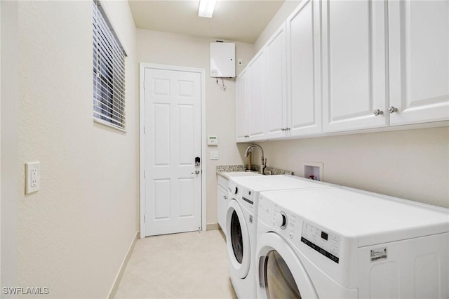 11643 Meadowrun Cir, Fort Myers, FL 33913 - laundry area with cabinet space, water heater, washer and clothes dryer, and baseboards