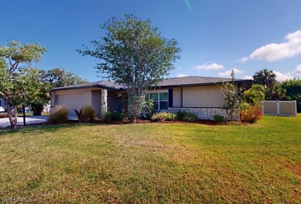 ranch-style house with a front lawn and a garage