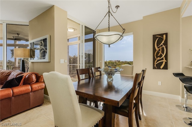 tiled dining area featuring floor to ceiling windows