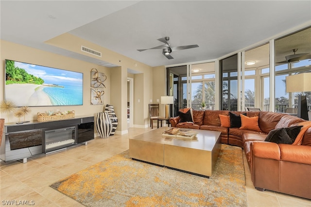 living room featuring expansive windows, ceiling fan, and light tile flooring