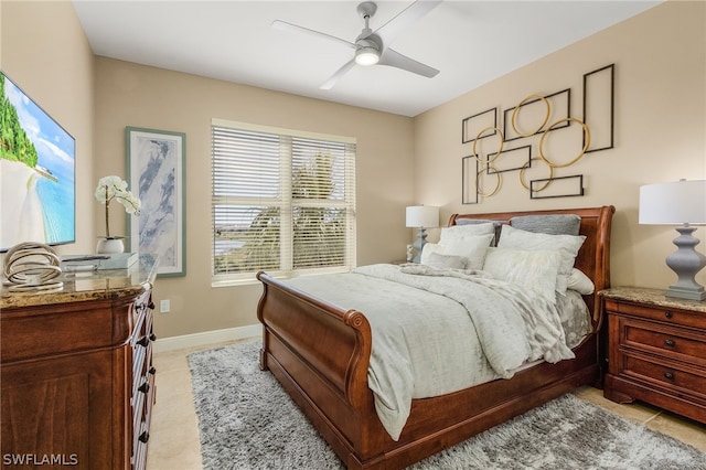 bedroom with ceiling fan and light tile floors