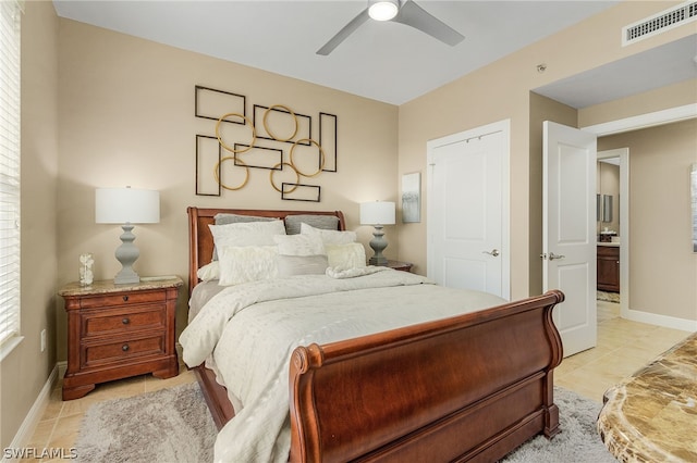 tiled bedroom featuring ceiling fan