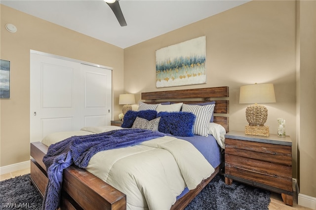 bedroom featuring a closet, wood-type flooring, and ceiling fan