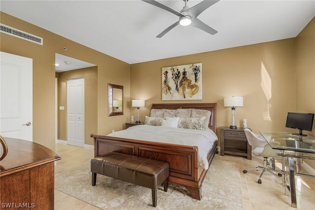 bedroom with ceiling fan, a closet, and light tile floors