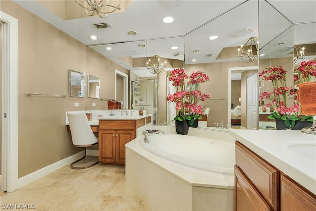 bathroom featuring tile floors, a notable chandelier, a washtub, and vanity with extensive cabinet space